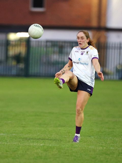 Kate Murray punt kicks ball with right foot