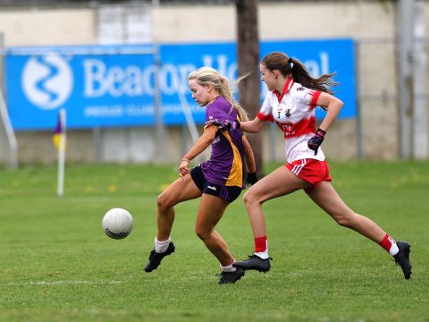 Kilmacud players kicks ball under pressure